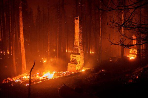 Chimneys stand at residences leveled by the Caldor Fire along Highway 50, in Eldorado National Forest, Calif., on Aug. 29, 2021. (Noah Berger/AP Photo)