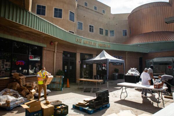 Los Angeles Rescue Mission workers complete day to day assignments for Skid Row's homeless community in Los Angeles, Calif., on June 9, 2021. (John Fredricks/The Epoch Times)