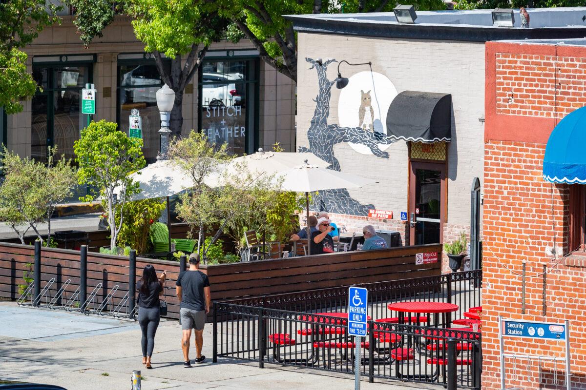 Customers walk into The Night Owl Coffeeshop in Fullerton, Calif., on Aug. 12, 2021. (John Fredricks/The Epoch Times)