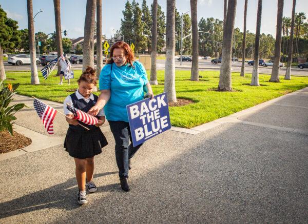 Barbara George and her daughter Hannah gather with a small group Orange County locals to show support for law enforcement and America in Irvine, Calif., on Oct. 11, 2021. (John Fredricks/The Epoch Times)