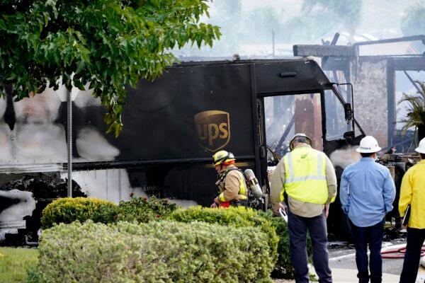 Fire and safety crews work the scene of a small plane crash in Santee, Calif., on Oct. 11, 2021. (Gregory Bull/AP Photo)