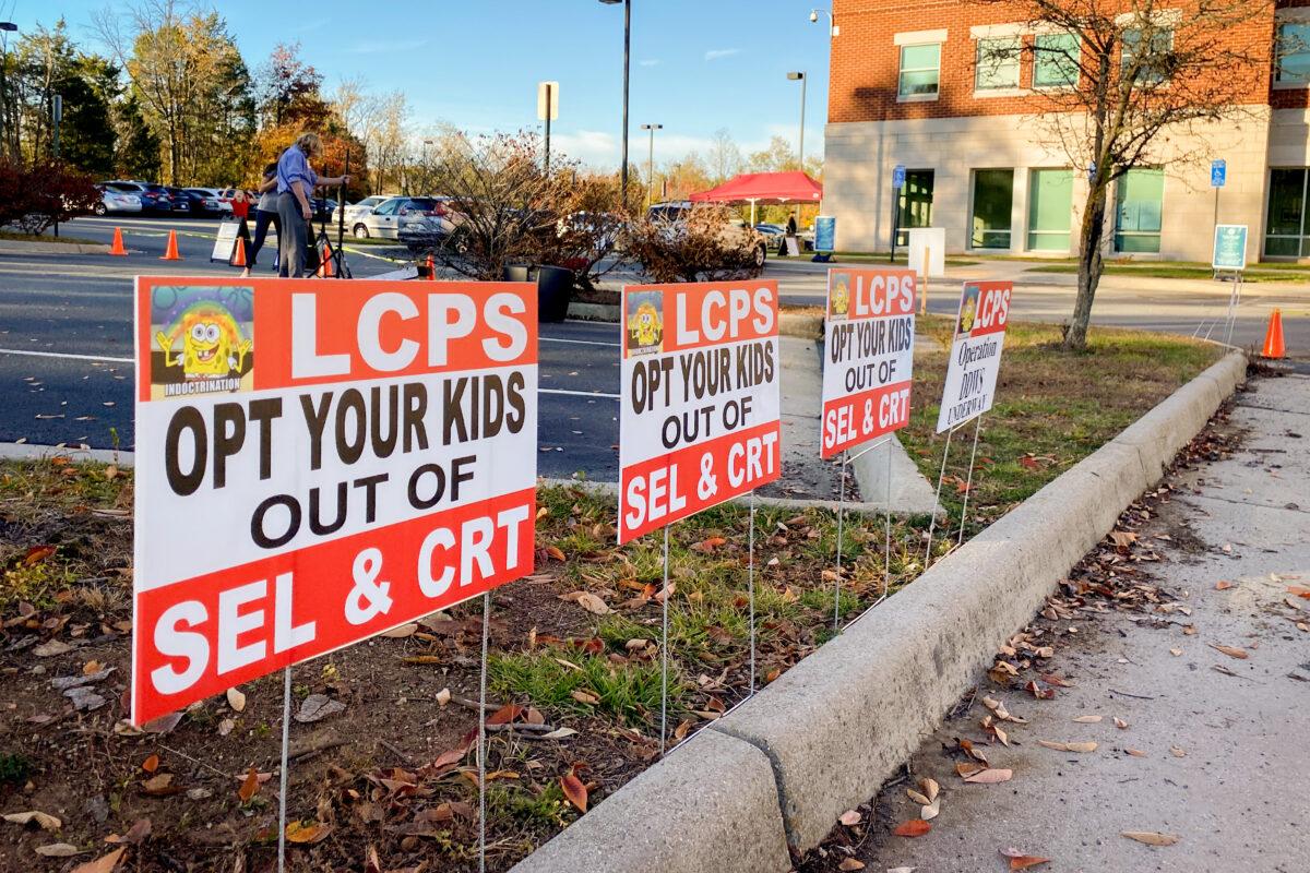 Signs against critical race theory in front of the Loudoun County School Administration building in Virginia on Nov. 9, 2021. (Terri Wu/The Epoch Times)