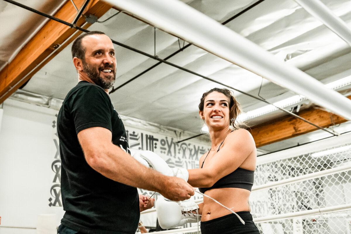 RVCA head coach Jason Parillo, left, helps Mackenzie Dern prepare for a workout at the RVCA Training Center in Costa Mesa, Calif. (Courtesy Joseph Baura)