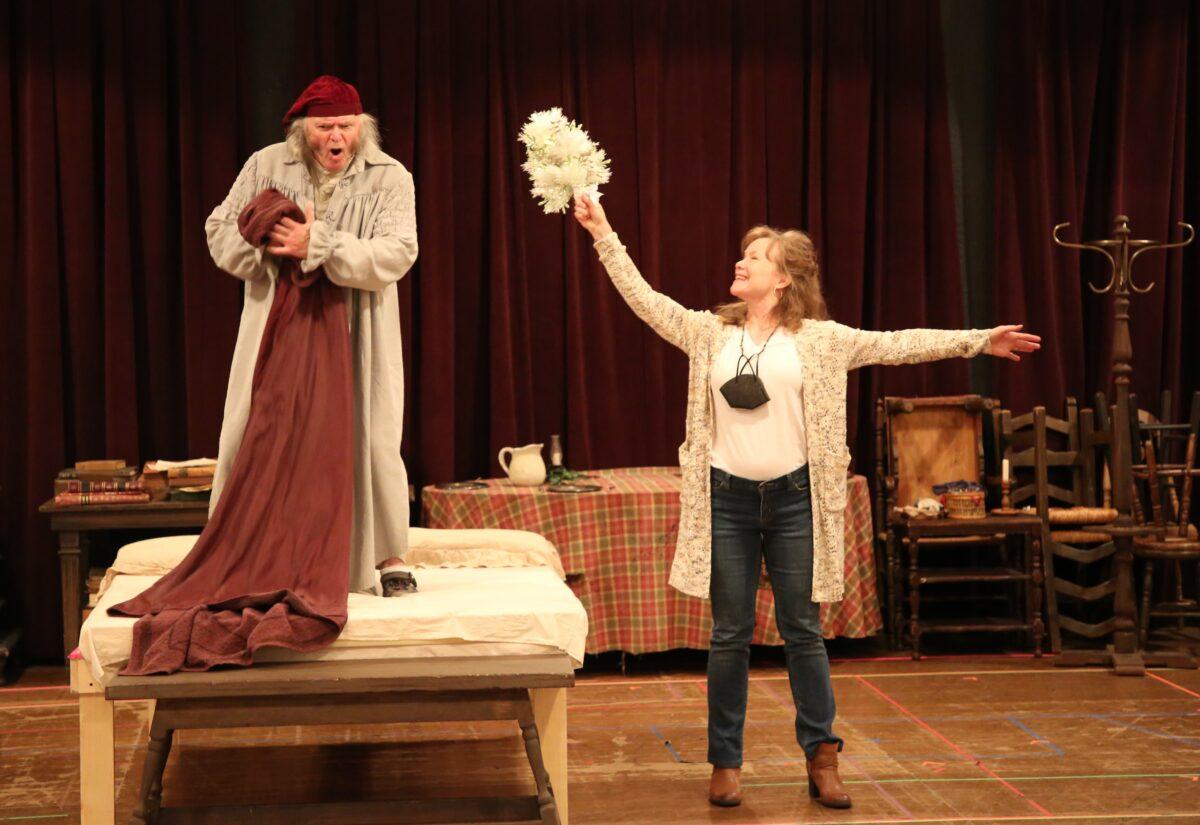 Richard Doyle (L) plays Ebenezer Scrooge with his wife Jennifer Parsons as the Ghost of Christmas Past in A Christmas Carol at South Coast Repertory in Costa Mesa, Calif., from Nov. 27 to Dec. 26, 2021. (Nicholas Pilapil/SCR)