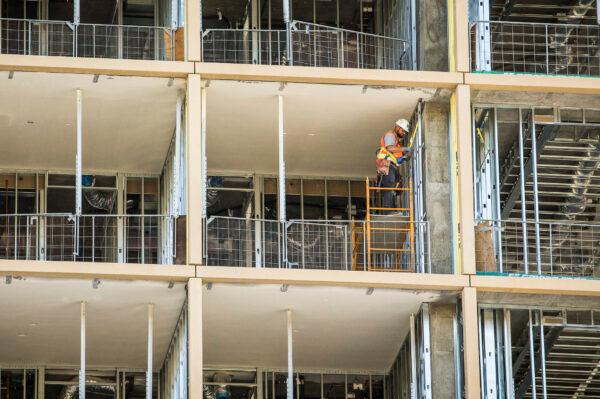 A construction worker works on a high-rise building in Los Angeles on March 19, 2018. (John Fredricks/The Epoch Times)