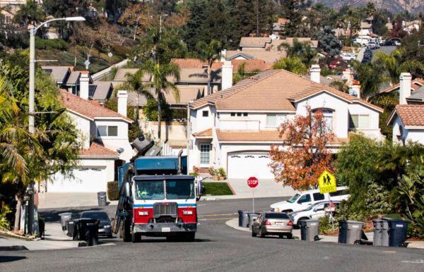 A truck gathers and disposes of garbage in Lake Forest, Calif., on Dec. 3, 2021. (John Fredricks/The Epoch Times)