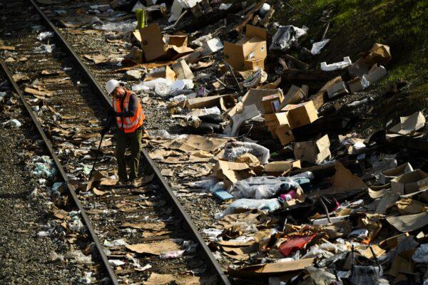 A railroad worker inspects a track as he repairs a section of Union Pacific train tracks following a derailment in Los Angeles on Jan. 16, 2022. (Patrick T. Fallon/AFP via Getty Images)