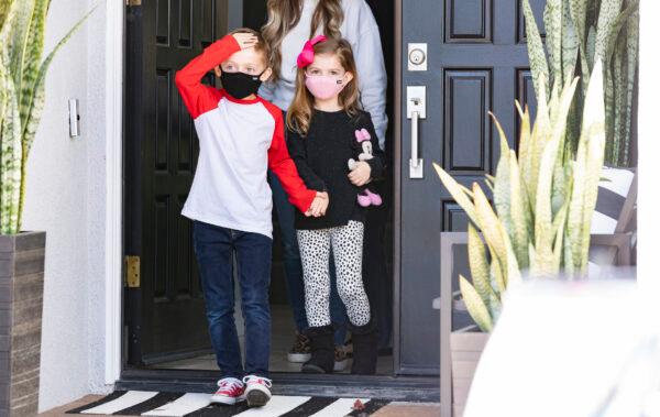 Seven-year-old Jacob Hayward receives gifts from his favorite mailman from the United States Postal Service, Van Singletary, at his home in Laguna Niguel, Calif., on Jan. 24, 2022. (John Fredricks/The Epoch Times)