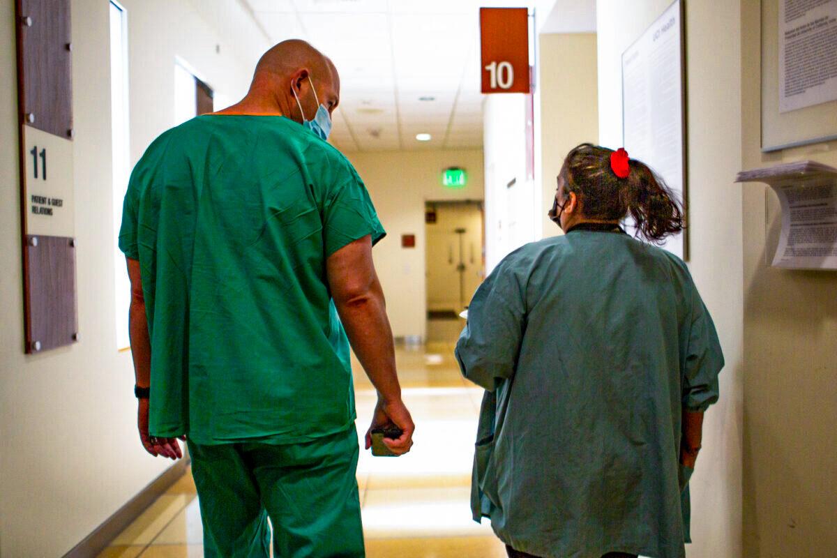 Hospital staff members walk down a hall at UCI Medical Center in Orange., Calif., on Dec. 16, 2020. (John Fredricks/The Epoch Times)