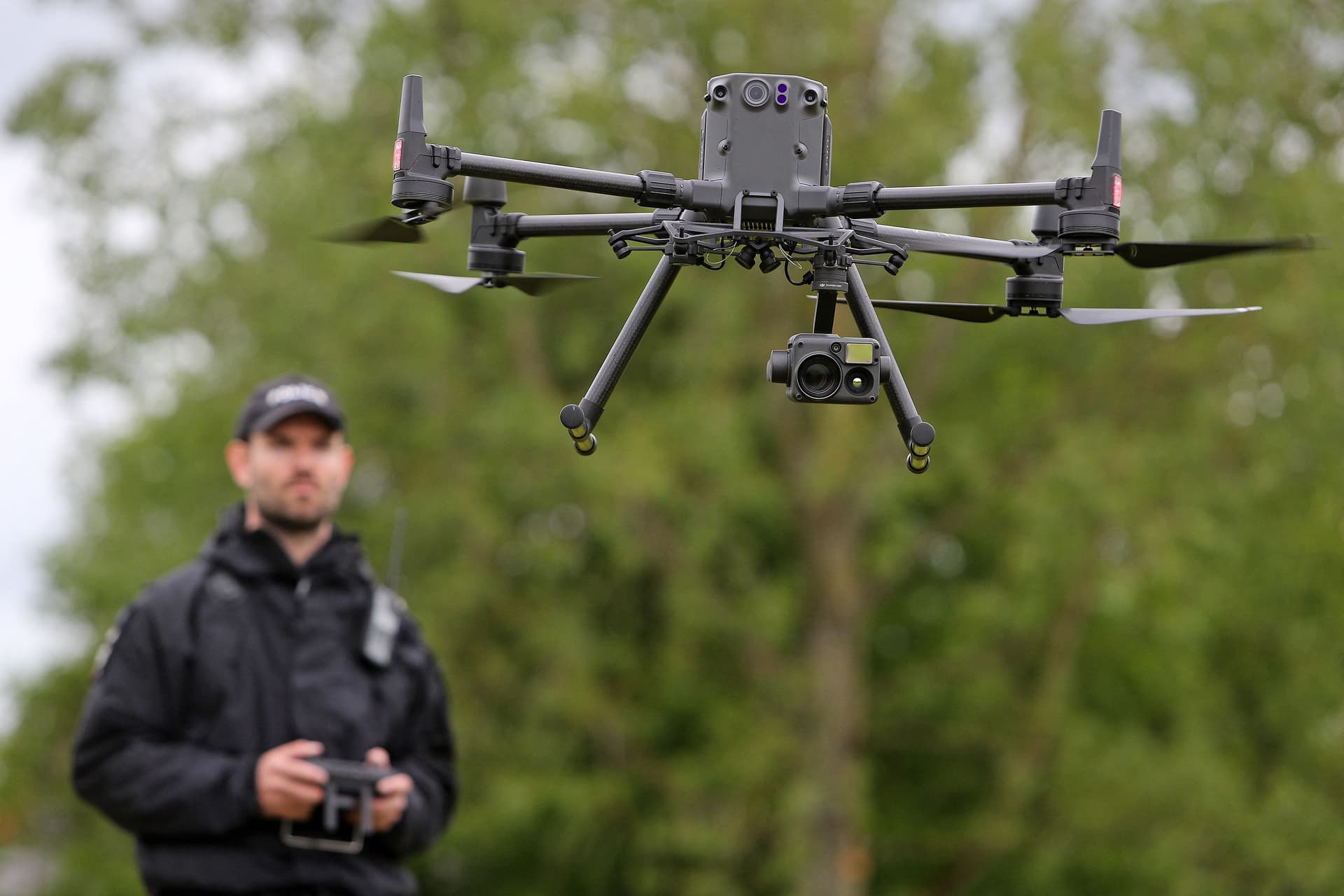 Acting Police Sergeant Chris Linzey pilots a DJI Matrice M300 drone during a demonstration for reporters at police headquarters in Exeter, southwest England, on May 25, 2021. (Geoff Caddick/AFP via Getty Images)