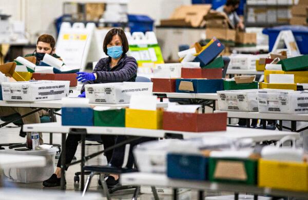 Los Angeles Registrar's personnel process mail-in voting ballots in Pomona, Calif., on Aug. 31, 2021. (John Fredricks/The Epoch Times)
