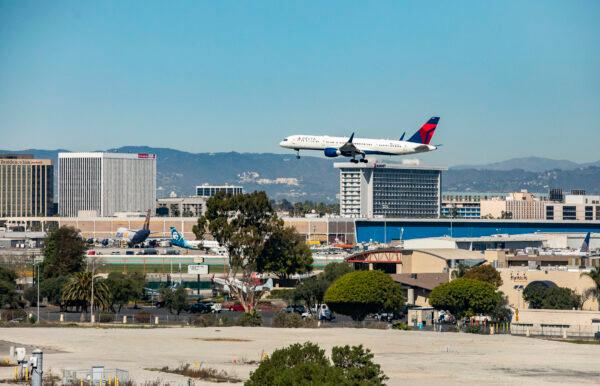 A plane flies in for landing at Los Angeles International Airport on Feb. 18, 2022. (John Fredricks/The Epoch Times)