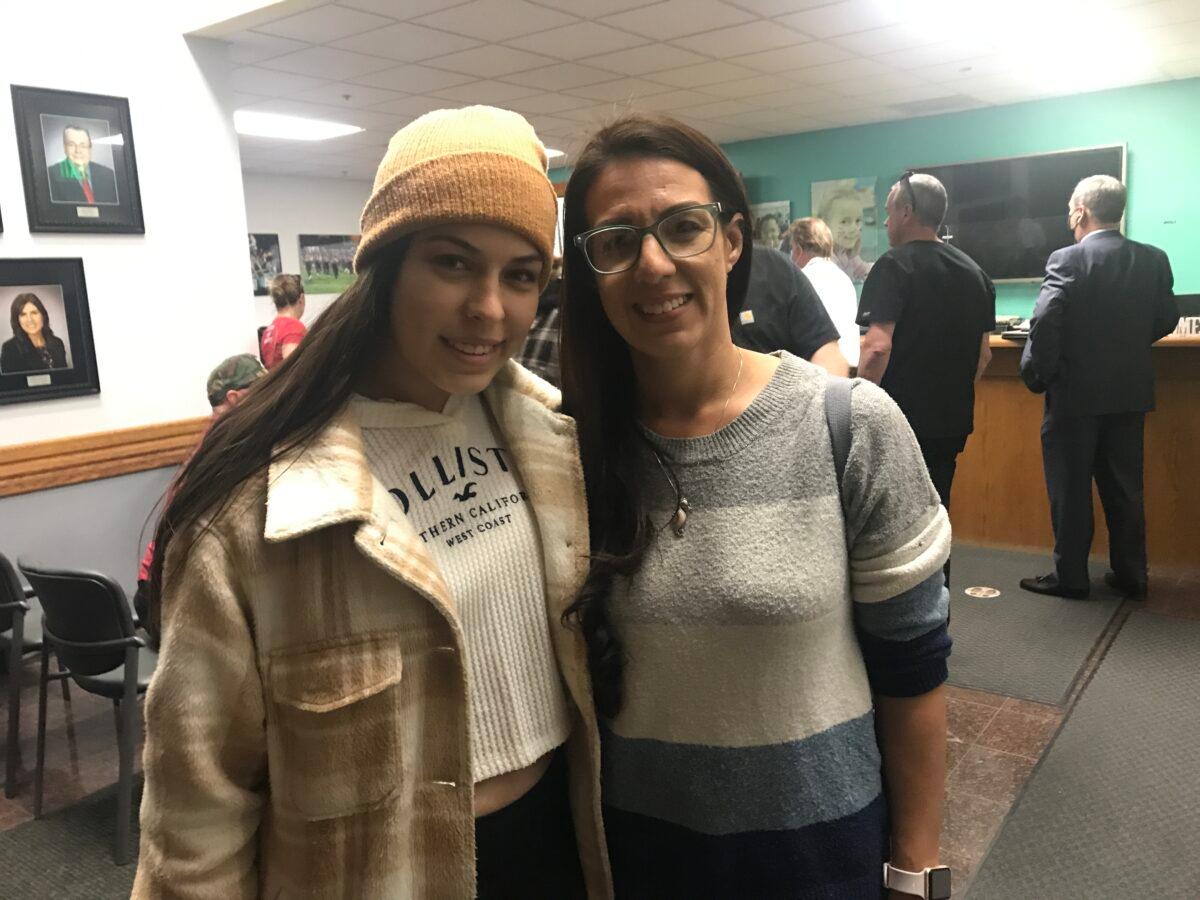 Stephanie Dawson and her daughter, a high school student, at a school board meeting in Murrieta, Calif. (Brad Jones/The Epoch Times)