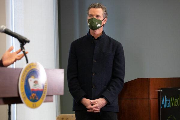 California Gov. Gavin Newsom speaks to reporters at AltaMed Urgent Care in Santa Ana, Calif., on March 25, 2021. (John Fredricks/The Epoch Times)