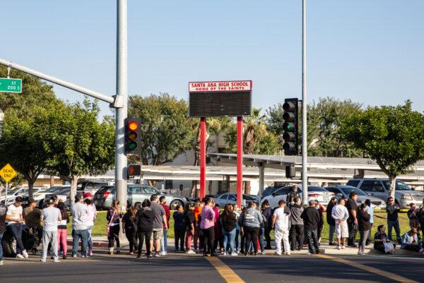 First responders including Santa Ana Police Department SWAT teams and Orange County Fire Authority HAZMAT crews secure Santa Ana High School as parents and family members wait for students on lock down after bomb and weapon threats circulated at the school in Santa Ana, Calif., on March 10, 2022. (John Fredricks/The Epoch Times)
