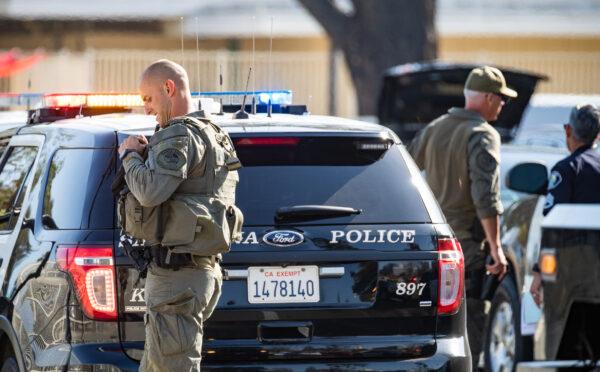 First responders including Santa Ana Police Department SWAT teams and Orange County Fire Authority HAZMAT crews secure Santa Ana High School as parents and family members wait for students on lock down after bomb and weapon threats circulated at the school in Santa Ana, Calif., on March 10, 2022. (John Fredricks/The Epoch Times)