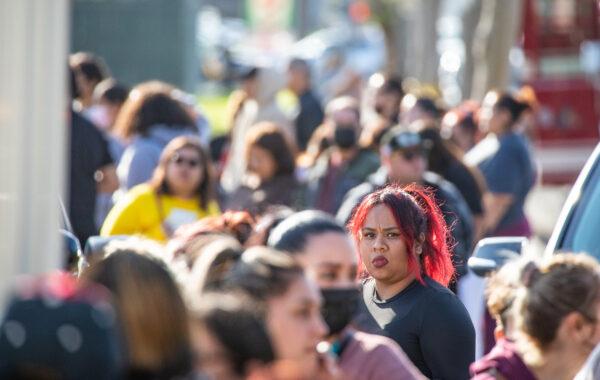 First responders including Santa Ana Police Department SWAT teams and Orange County Fire Authority HAZMAT crews secure Santa Ana High School as parents and family members wait for students on lock down after bomb and weapon threats circulated at the school in Santa Ana, Calif., on March 10, 2022. (John Fredricks/The Epoch Times)