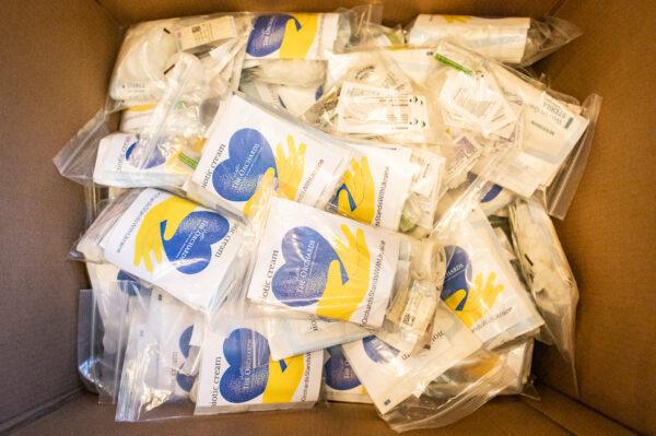 Seniors and medical staff at The Orchards Health Center help create and load first-aid kits to be delivered to Ukraine in Ranch Mission Viejo, Calif., on March 15, 2022. (John Fredricks/The Epoch Times)
