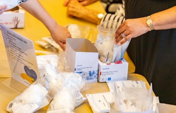 Seniors and medical staff at The Orchards Health Center help create and load first-aid kits to be delivered to Ukraine in Ranch Mission Viejo, Calif., on March 15, 2022. (John Fredricks/The Epoch Times)