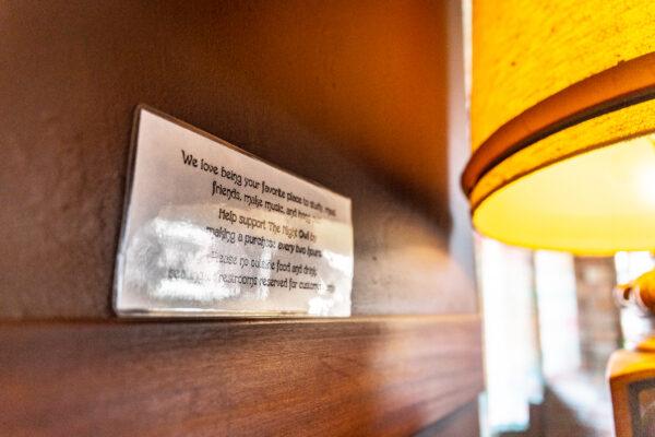 Signs displaying no outside food or drink are located on several walls of The Night Owl Coffeeshop, in Fullerton, Calif., on Aug. 12, 2021. (John Fredricks/The Epoch Times)