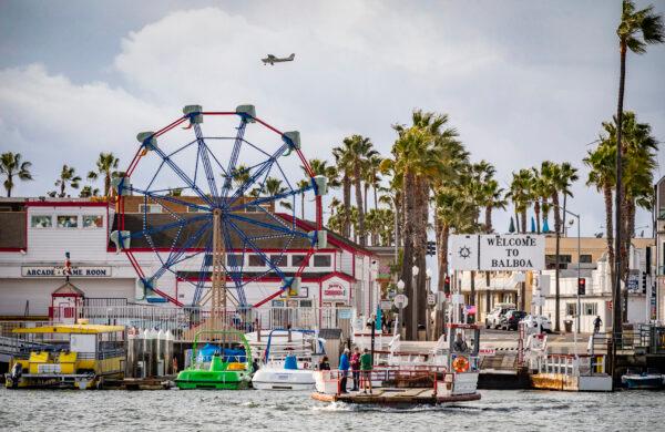People enjoy riding the Balboa Island Ferry boats across Newport Beach harbor on Dec. 29, 2021. (John Fredricks/The Epoch Times)