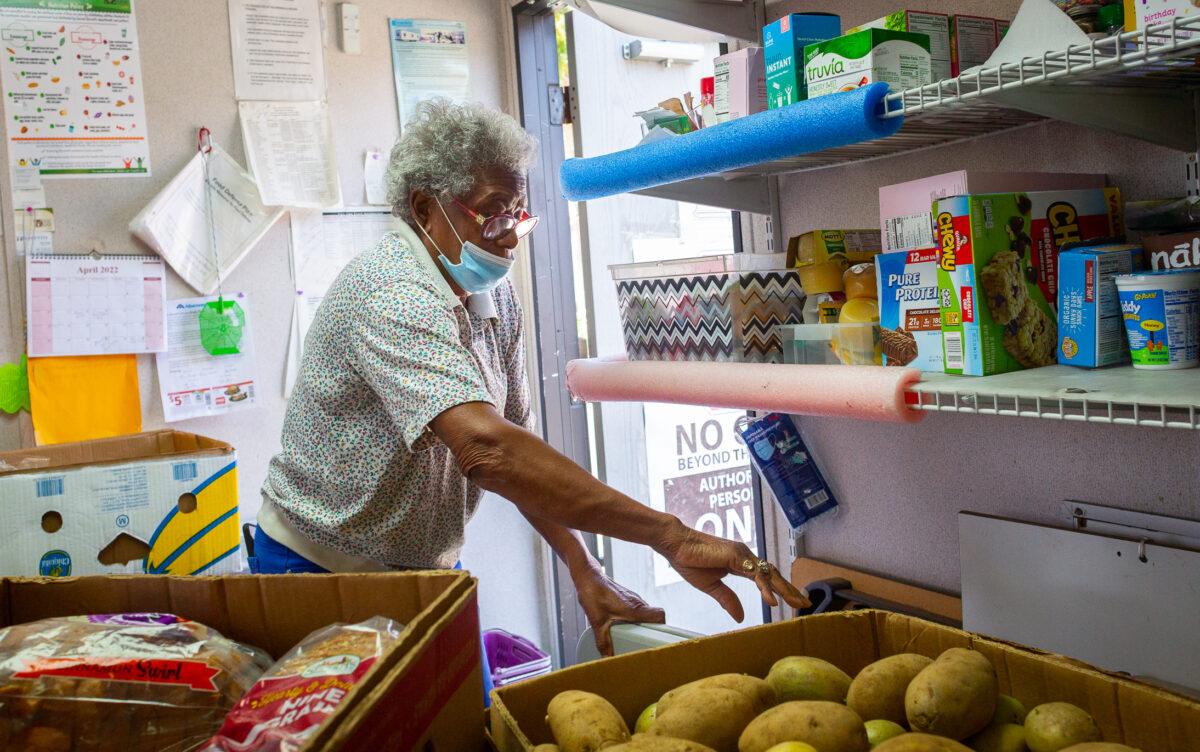 Ministry lead Gloria Banks organizes the food pantry ministry building area at Friendship Baptist Church in Yorba Linda, Calif., on April 5, 2022. (John Fredricks/The Epoch Times)