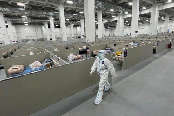 A staff member walks inside a makeshift hospital that will house COVID-19 patients in Shanghai, China on April 7, 2022. (STR/AFP via Getty Images)