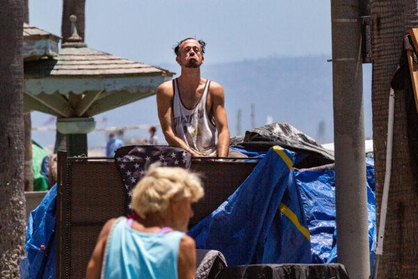 Homeless individuals in Venice Beach, Calif., roam around encampments on June 8, 2021. (John Fredricks/The Epoch Times)