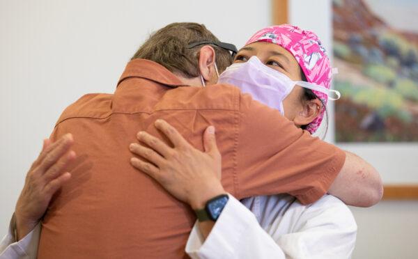 Burn victim Michael Zimmer hugs Dr. Theresa L. Chin at UCI Medical Center in Orange, Calif., on April 13, 2022. (John Fredricks/The Epoch Times)