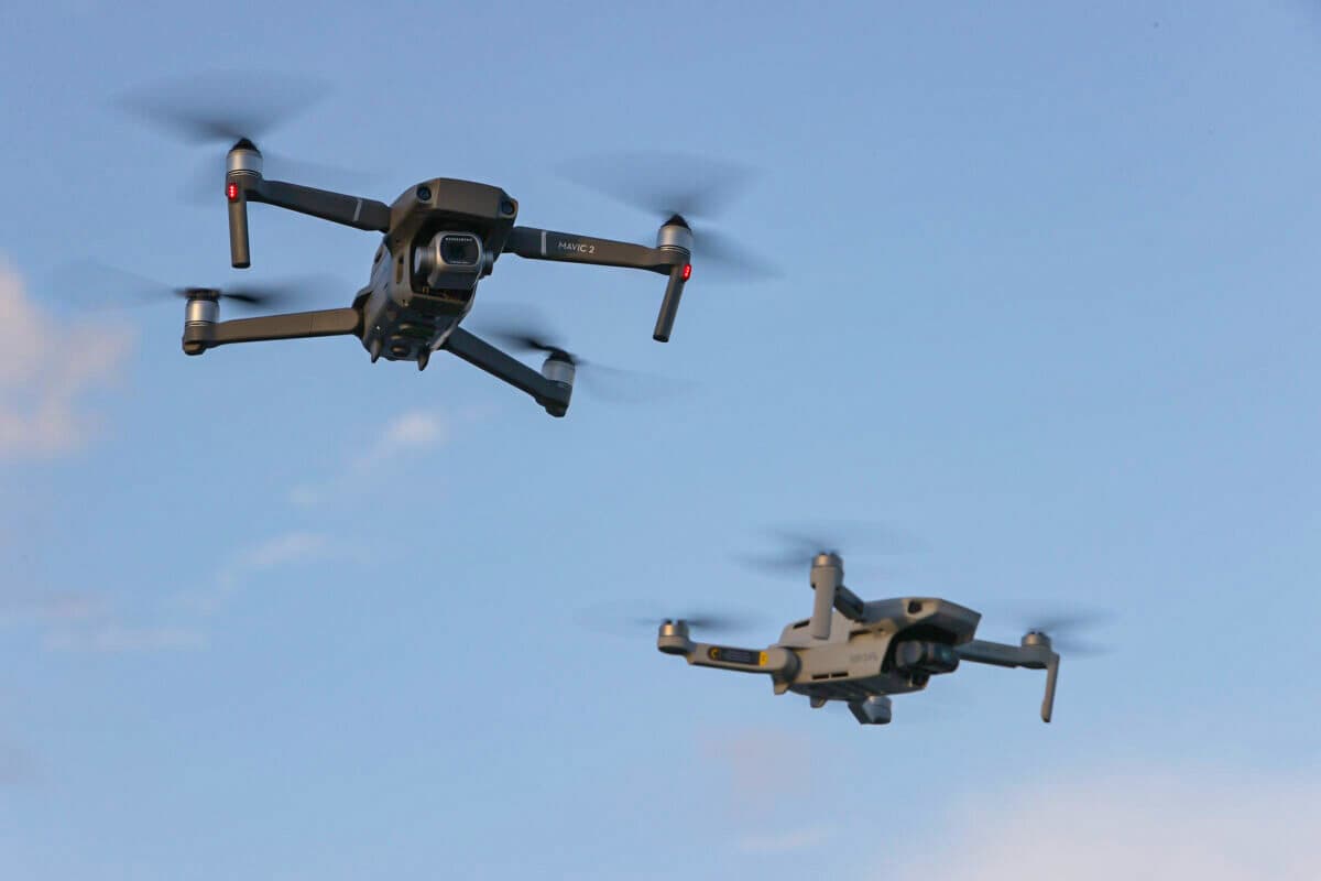 A DJI Mavic 2 Pro and a DJI Mavic Mini made by the Chinese drone maker fly near each other in Miami on Dec. 15, 2021. (Joe Raedle/Getty Images)