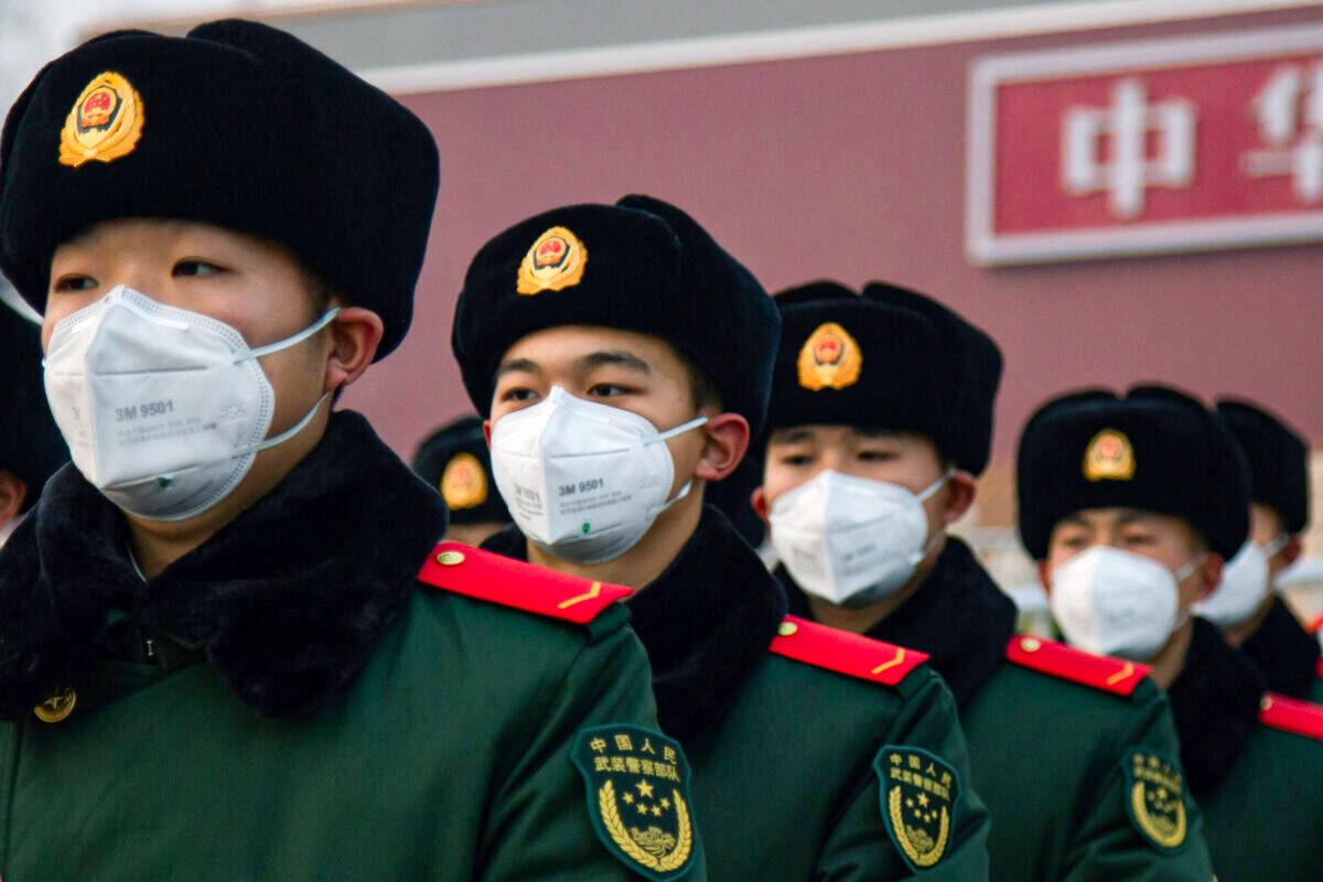Chinese police officers wearing masks stand in front of the Tiananmen Gate in Beijing, China, on Jan. 26, 2020. (Betsy Joles/Getty Images)