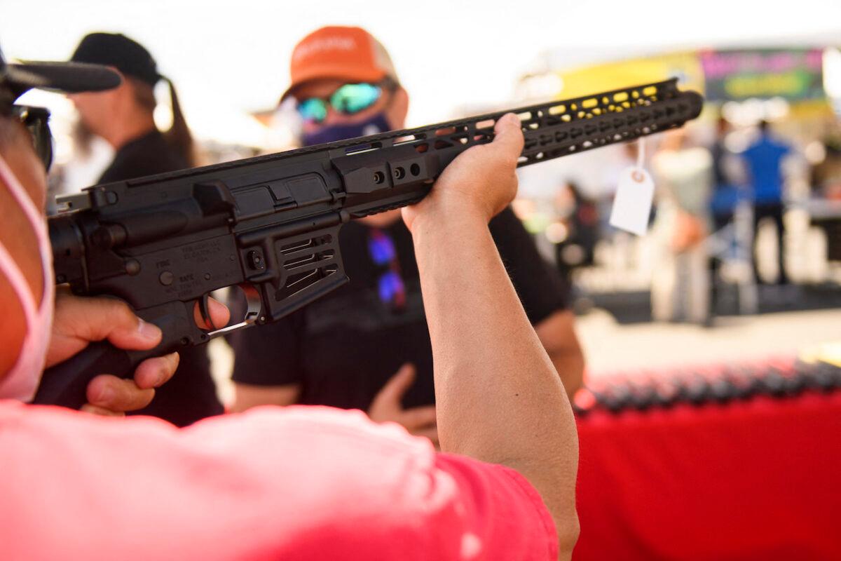 A person holds a California-legal featureless AR-15 style rifle in Costa Mesa, Calif., on June 5, 2021. (Patrick Fallon/AFP via Getty Images)