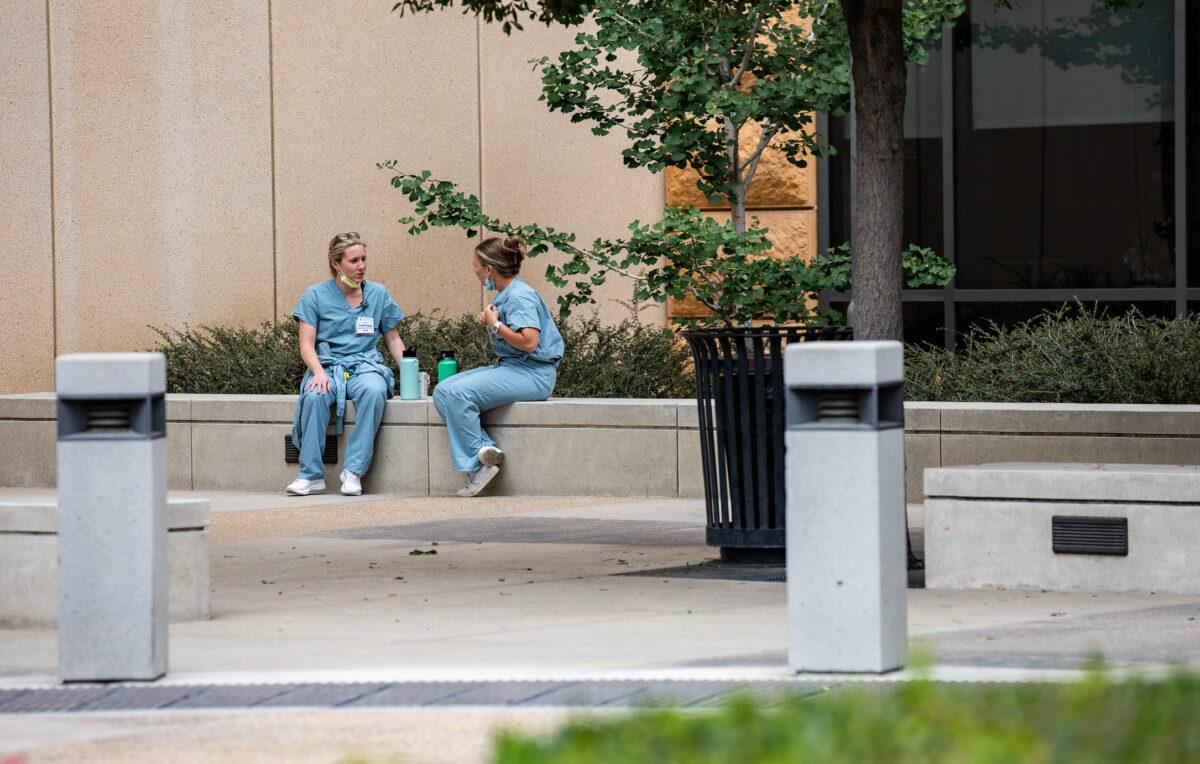 Nurses sit in front of UCI Medical Center in Orange, Calif., on June 3, 2022. (John Fredricks/The Epoch Times)