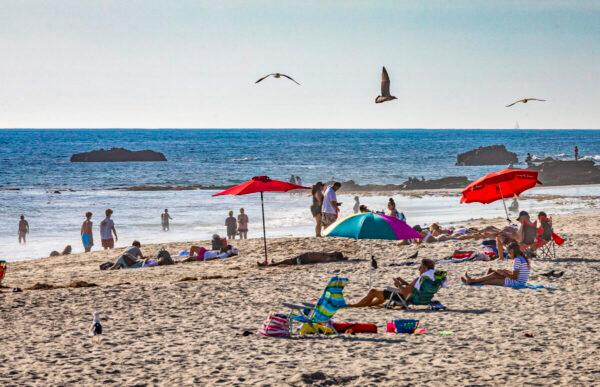 People enjoy the beach in Laguna Beach, Calif., on Dec. 15, 2020. (John Fredricks/The Epoch Times)