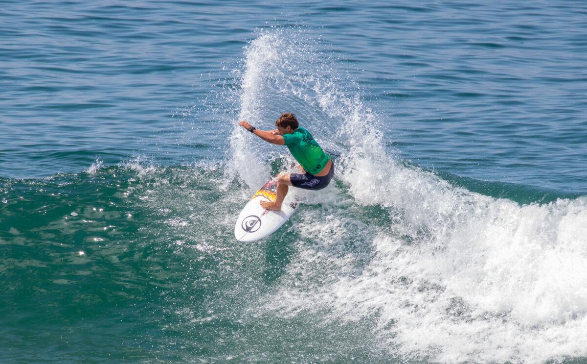 A surfer competes on the opening day of the Vans US Open of Surfing in Huntington Beach, Calif., on July 30, 2022. (John Fredricks/The Epoch Times)