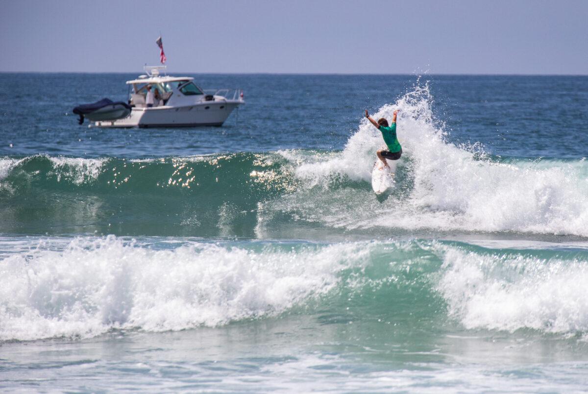 A surfer competes on the opening day of the Vans US Open of Surfing in Huntington Beach, Calif., on July 30, 2022. (John Fredricks/The Epoch Times)