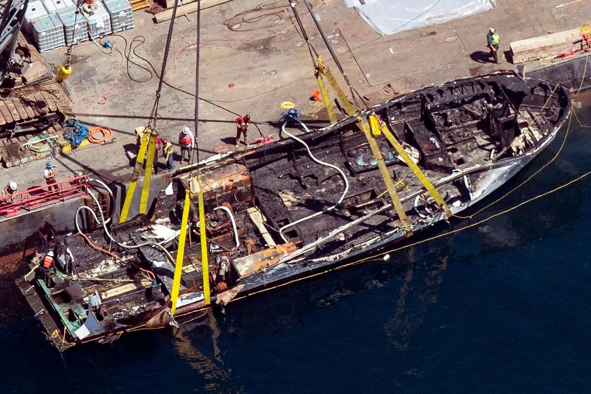 The burned hull of the dive boat Conception is brought to the surface by a salvage team in the Santa Barbara Channel off Santa Cruz Island in Southern California on Sept. 12, 2019. (Brian van der Brug/Los Angeles Times via AP)