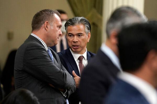 California Attorney General Rob Bonta, right, talks with Assemblyman Adam Gray, (D-Merced), as lawmakers discussed a gun control measure in the Assembly in Sacramento on Sept. 1, 2022. (Rich Pedroncelli/AP Photo)