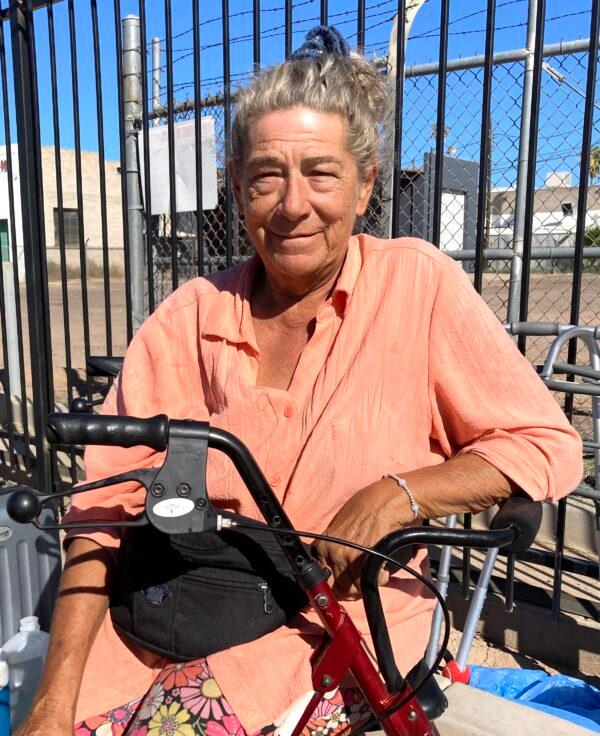 Pam Bejarno, 70, has been homeless in "the Zone," a growing homeless encampment in Phoenix, for months. She's had just about everything stolen from her, including her heart medication. Here, she sits in the blistering sun on Sept. 18 on a medical scooter. (Allan Stein/The Epoch Times)