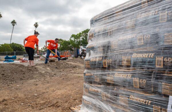 Volunteers work together in assembling Anaheim's newest playground in Anaheim, Calif., on Sept. 16, 2022. (John Fredricks/The Epoch Times)