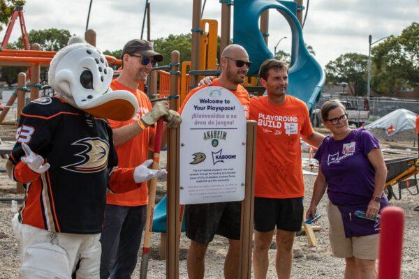 Volunteers work together in assembling Anaheim's newest playground in Anaheim, Calif., on Sept. 16, 2022. (John Fredricks/The Epoch Times)