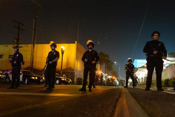 Individuals in downtown Los Angeles were arrested on various charges and loaded into LAPD buses on Nov. 3, 2020. Law enforcement agencies are on high alert the remainder of the week for post-election crimes. Downtown Los Angeles, Calif. (John Fredricks/The Epoch Times)