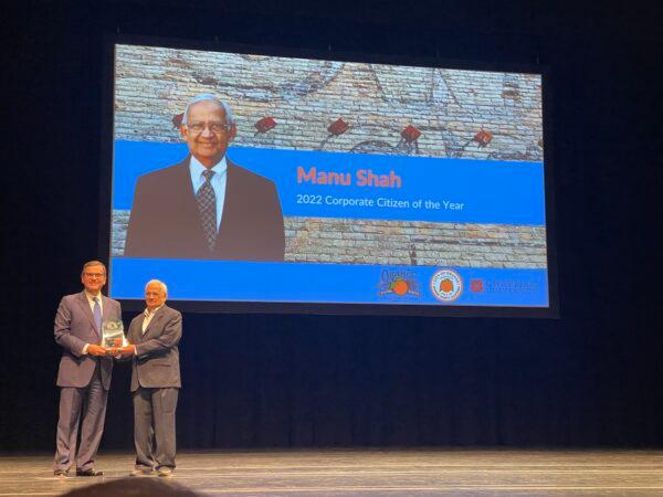 Manu Shah (L), co-founder and CEO of MS International, wins the Orange Chamber of Commerce's “Corporate Citizen” award in Orange, Calif., on Oct. 7. 2022. (Carol Cassis/The Epoch Times)