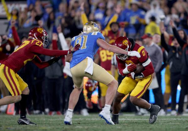 Korey Foreman (0) of the USC Trojans intercepts a pass thrown by Dorian Thompson-Robinson (1) of the UCLA Bruins during the fourth quarter in the game at Rose Bowl in Pasadena, Calif., on Nov. 19, 2022. (Harry How/Getty Images)