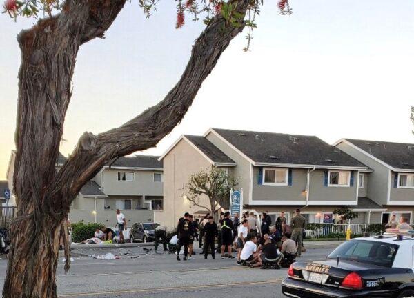 Law enforcement attend to those injured after an SUV struck recruits on a training run early in Whittier, Calif., on Nov. 16, 2022. (Christine Periman via AP)