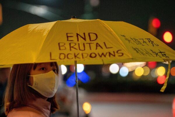 A person holding an umbrella with a slogan on it takes part in anti-CCP protests, amid China's "zero-COVID" policy, near the Chinese consulate in New York on Nov. 29, 2022. (David 'Dee' Delgado/Reuters)