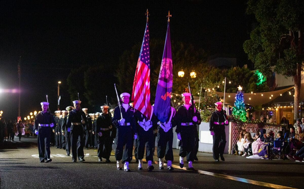 People walk through the Seal Beach Christmas Parade in Seal Beach, Calif., on Dec. 2, 2022. (John Fredricks/The Epoch Times)