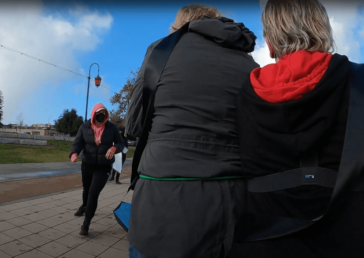 Women protesting the possible transfer of convicted killer Dana Rivers—a biological man who identifies as female—to a women’s prison are attacked outside of the Alameda County Superior Courthouse in Oakland, Calif., on Dec. 5, 2022. (Courtesy of Women's Declaration International, U.S.A.)