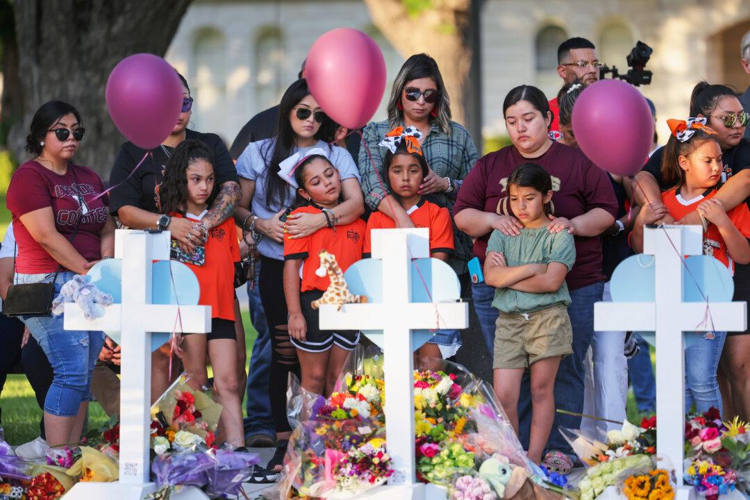 People visit memorials for victims of a mass shooting at Robb Elementary School in Uvalde, Texas, on May 26, 2022. Nineteen children and two teachers were killed in one of the deadliest school shootings in U.S. history. (Michael M. Santiago/Getty Images)