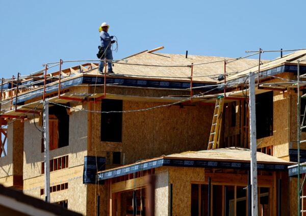 A worker walks on the roof of a new home under construction in Carlsbad, Calif., on Sept. 22, 2014. (Mike Blake/Reuters)